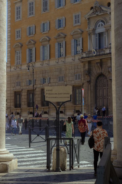 Free A lively street view near Vatican City featuring pedestrians and historic architecture. Stock Photo