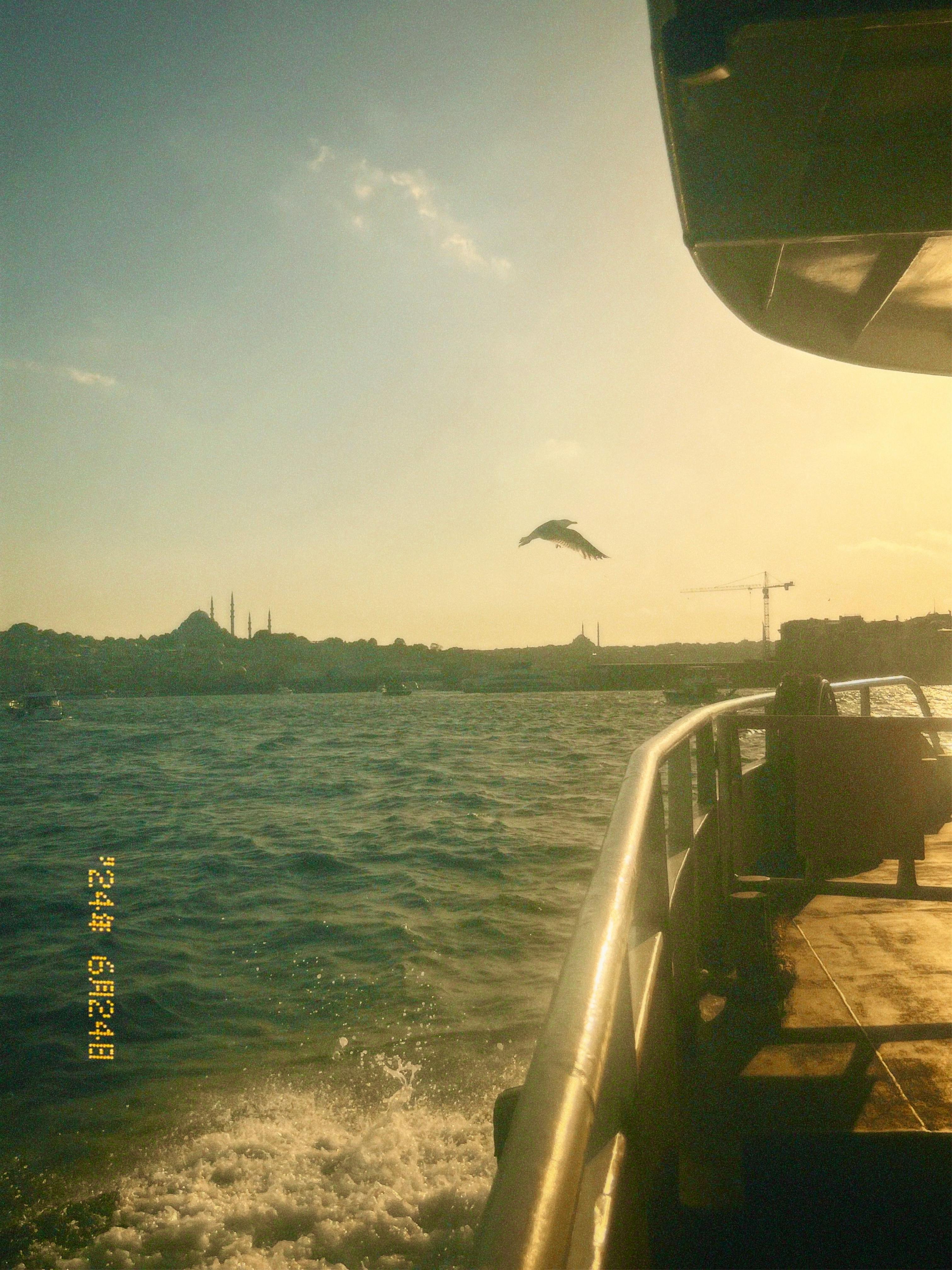Silhouetted skyline of Istanbul at sunset from a ferry on the Bosporus.
