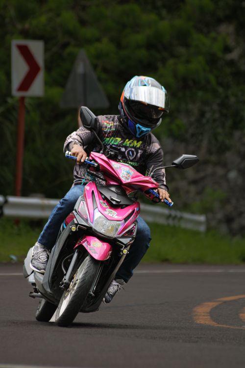Rider Taking Corner on Motor Scooter · Free Stock Photo