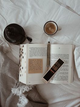 A cozy reading scene with an open book, coffee, and a serene ambiance.