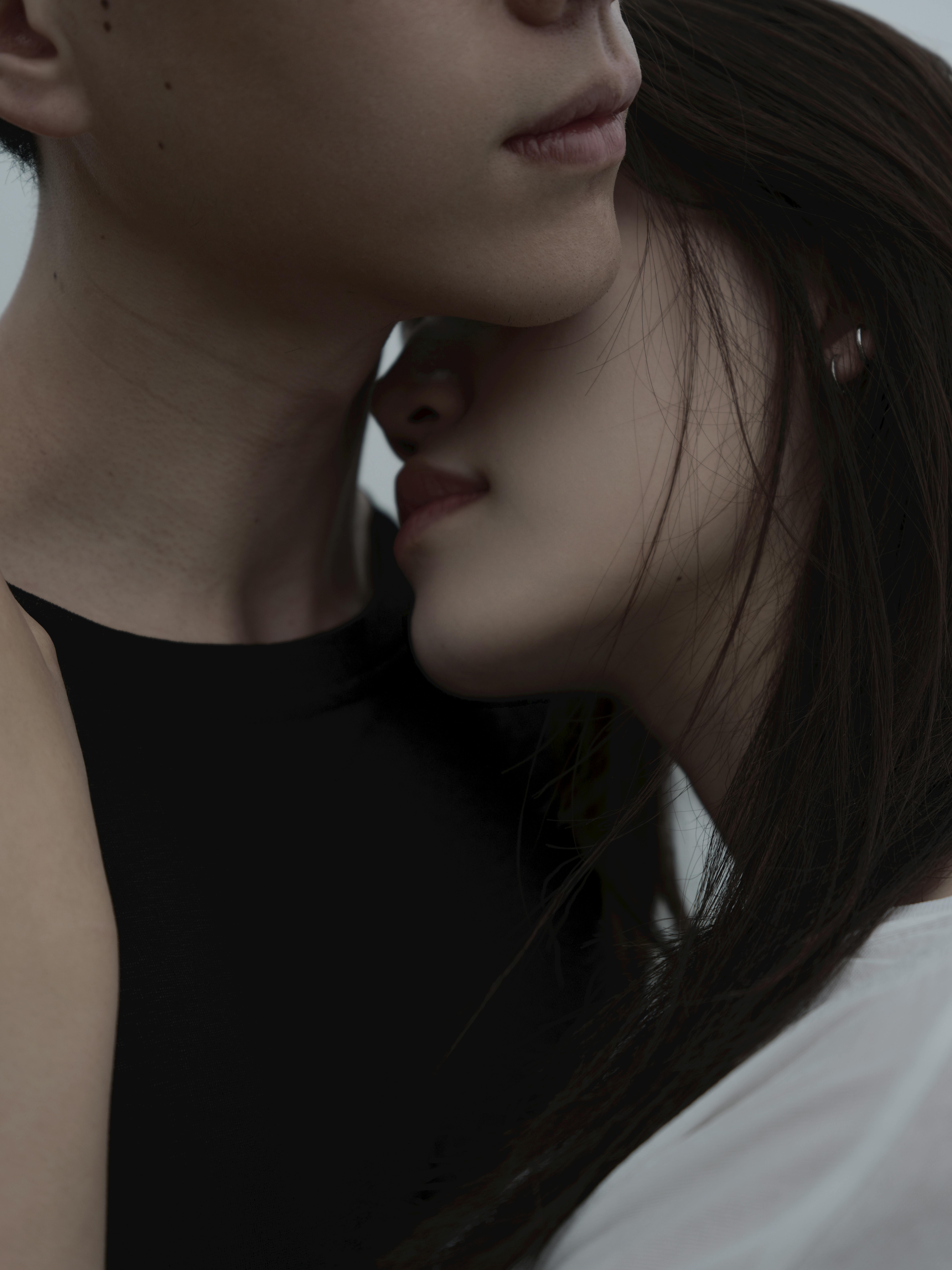 A close-up portrait of two adults embracing, showcasing emotional connection and warmth.
