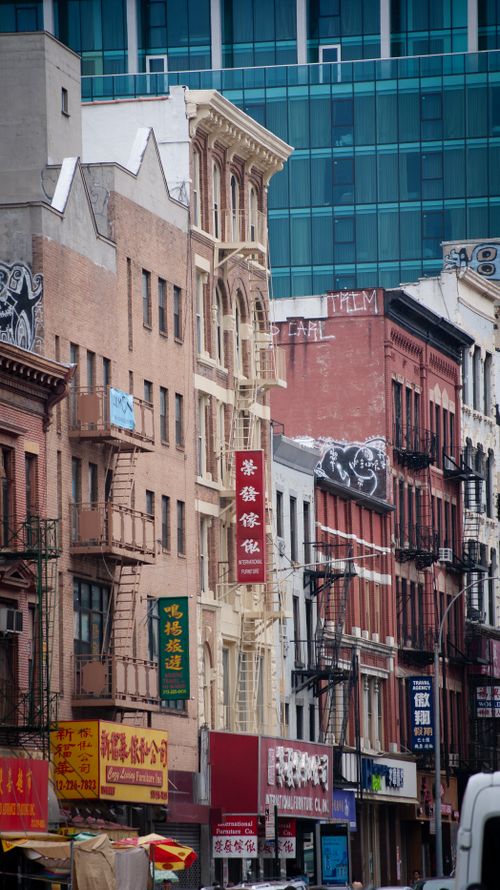 Free Lively urban street scene in Chinatown, New York City, featuring colorful signs and historic architecture. Stock Photo