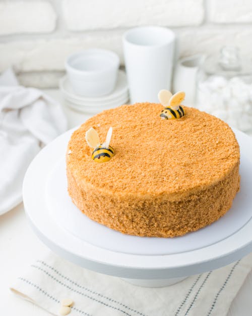 Brown Cake With Bees Decorations