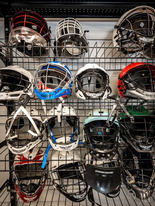 Free A variety of sports helmets displayed on shelves, showing different designs and colors. Stock Photo