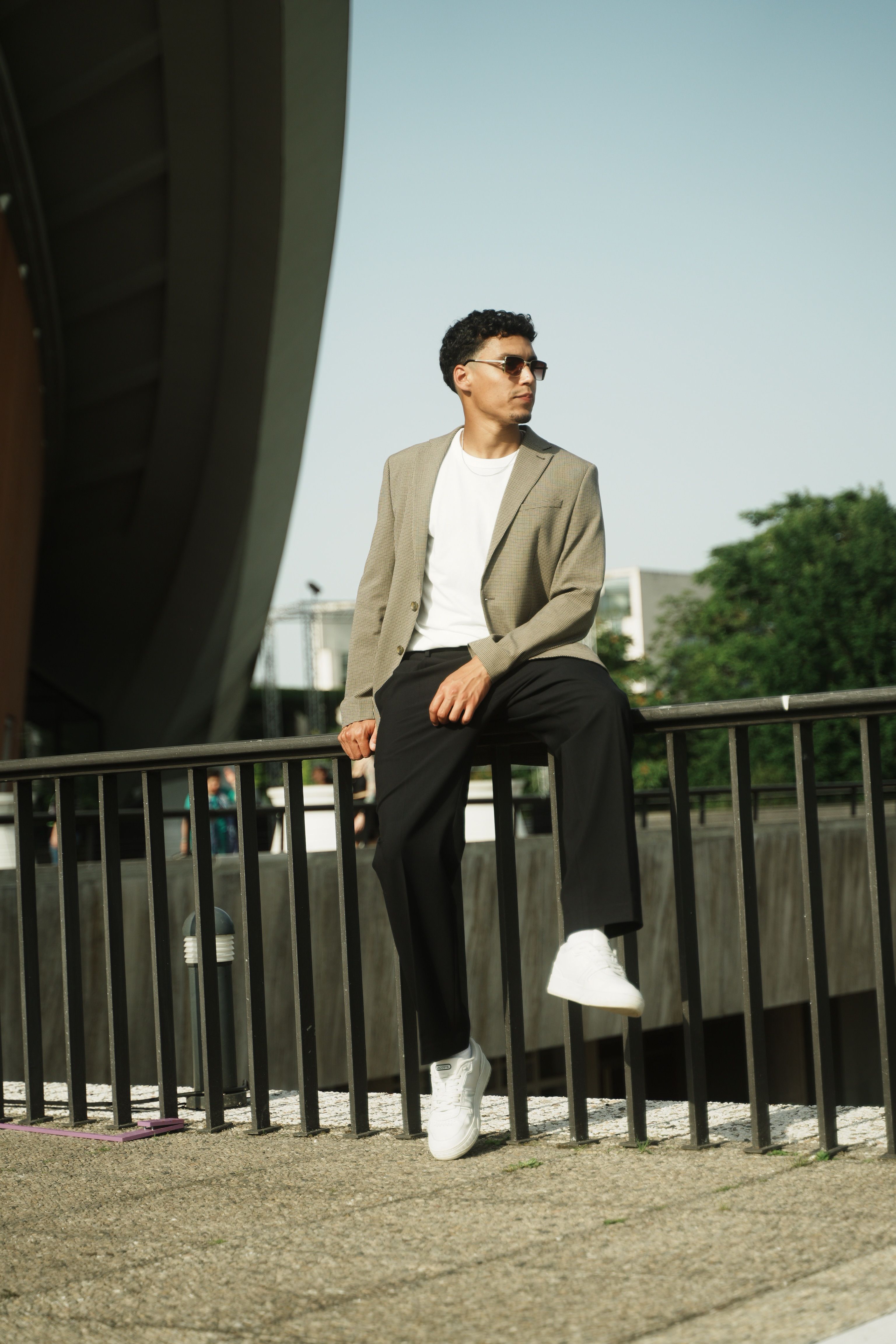 A Fashionable Man Sitting on the Railing · Free Stock Photo