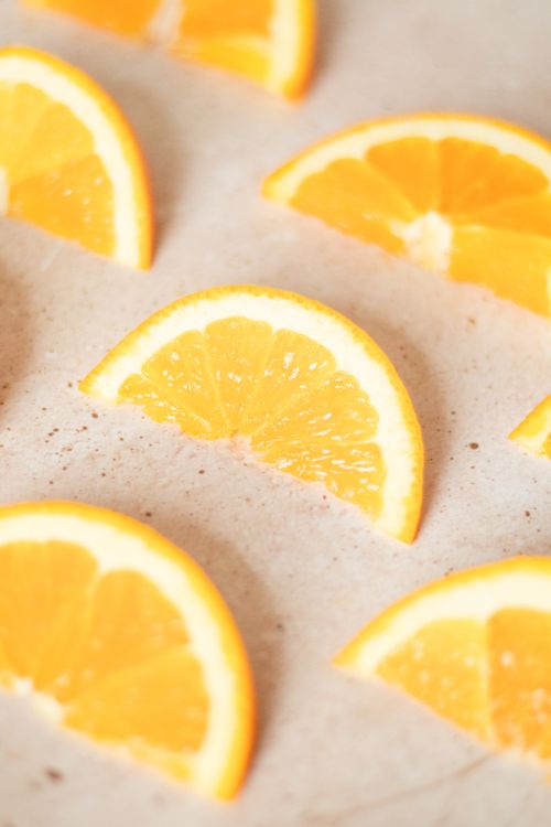 Free Bright and juicy orange slices arranged on a light background, highlighting freshness and nutrition. Stock Photo