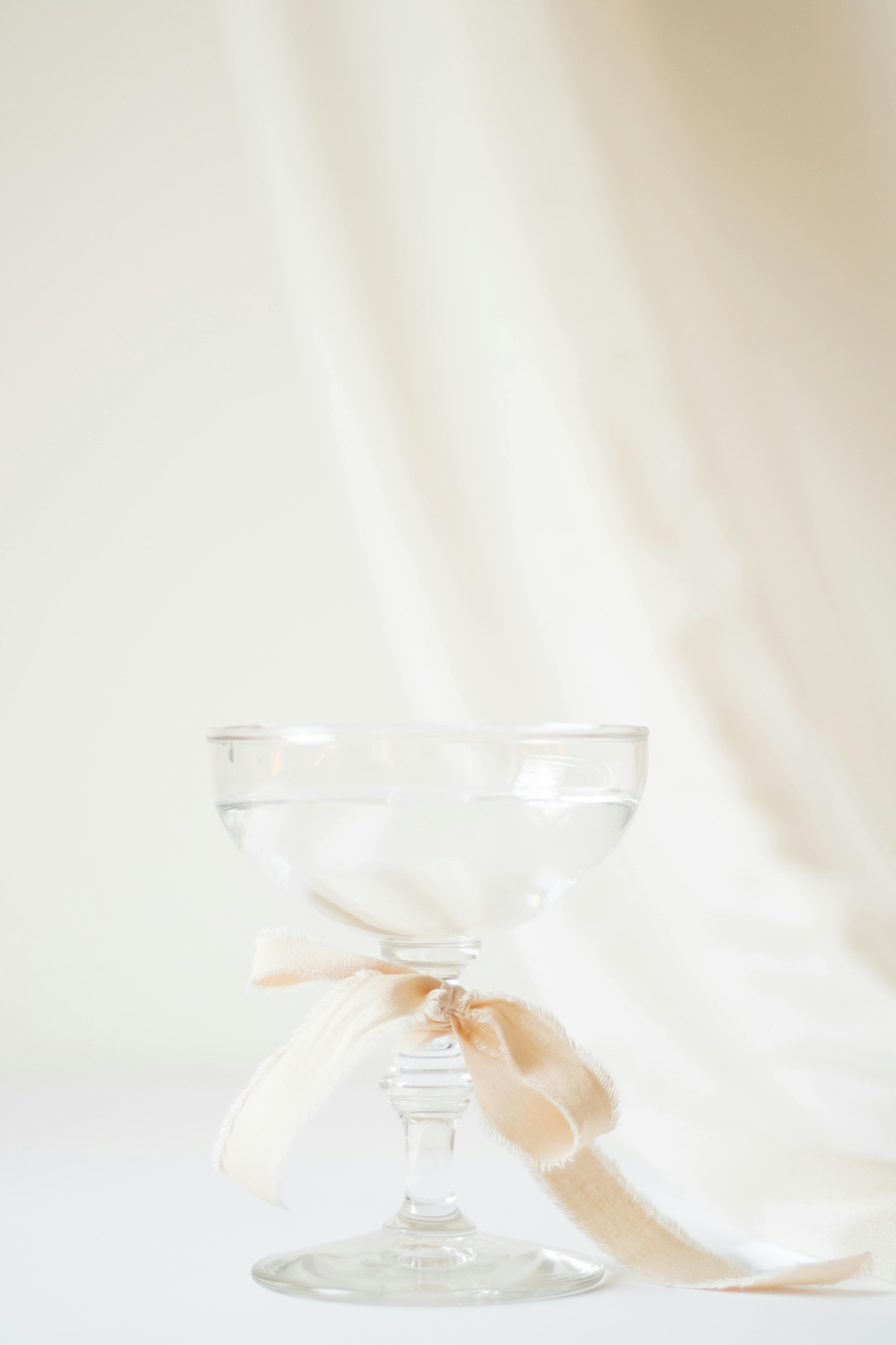 Champagne glass tied with a satin ribbon, perfect for weddings or celebrations.