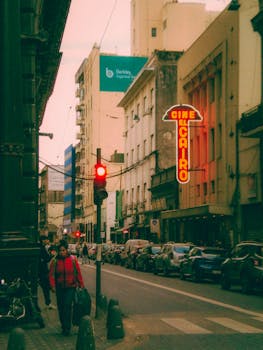Discover the vibrant urban street of Rosario, featuring the iconic El Cairo cinema.