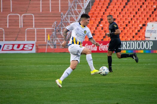 Dramatic action shot of a soccer player in a competitive match outdoors.