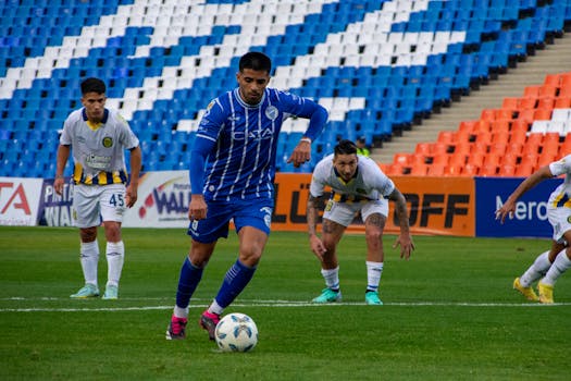 Players in a soccer match on a vibrant stadium field, showcasing teamwork and competition.