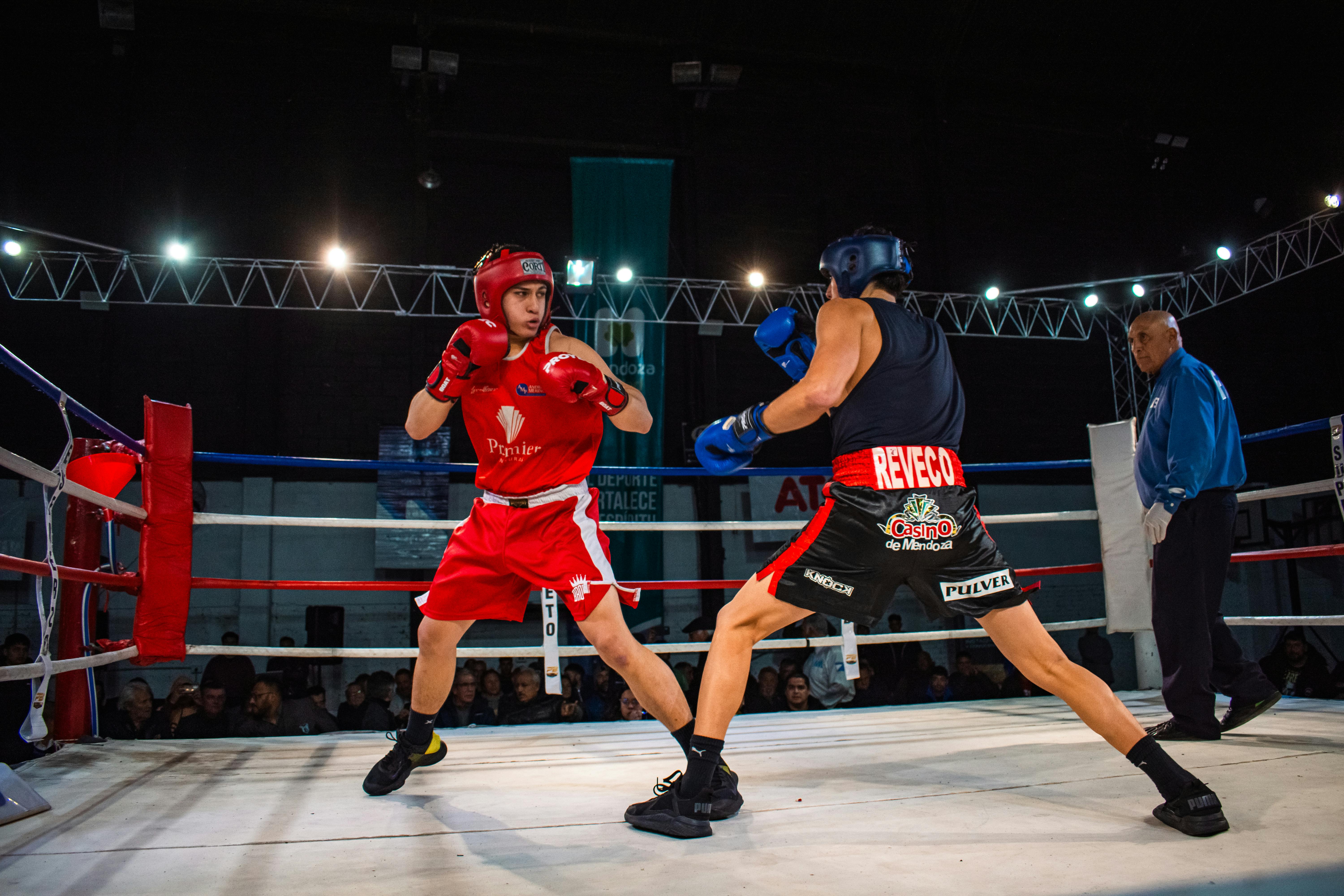 Free Two amateur boxers in a heated match inside a professional boxing ring. Stock Photo