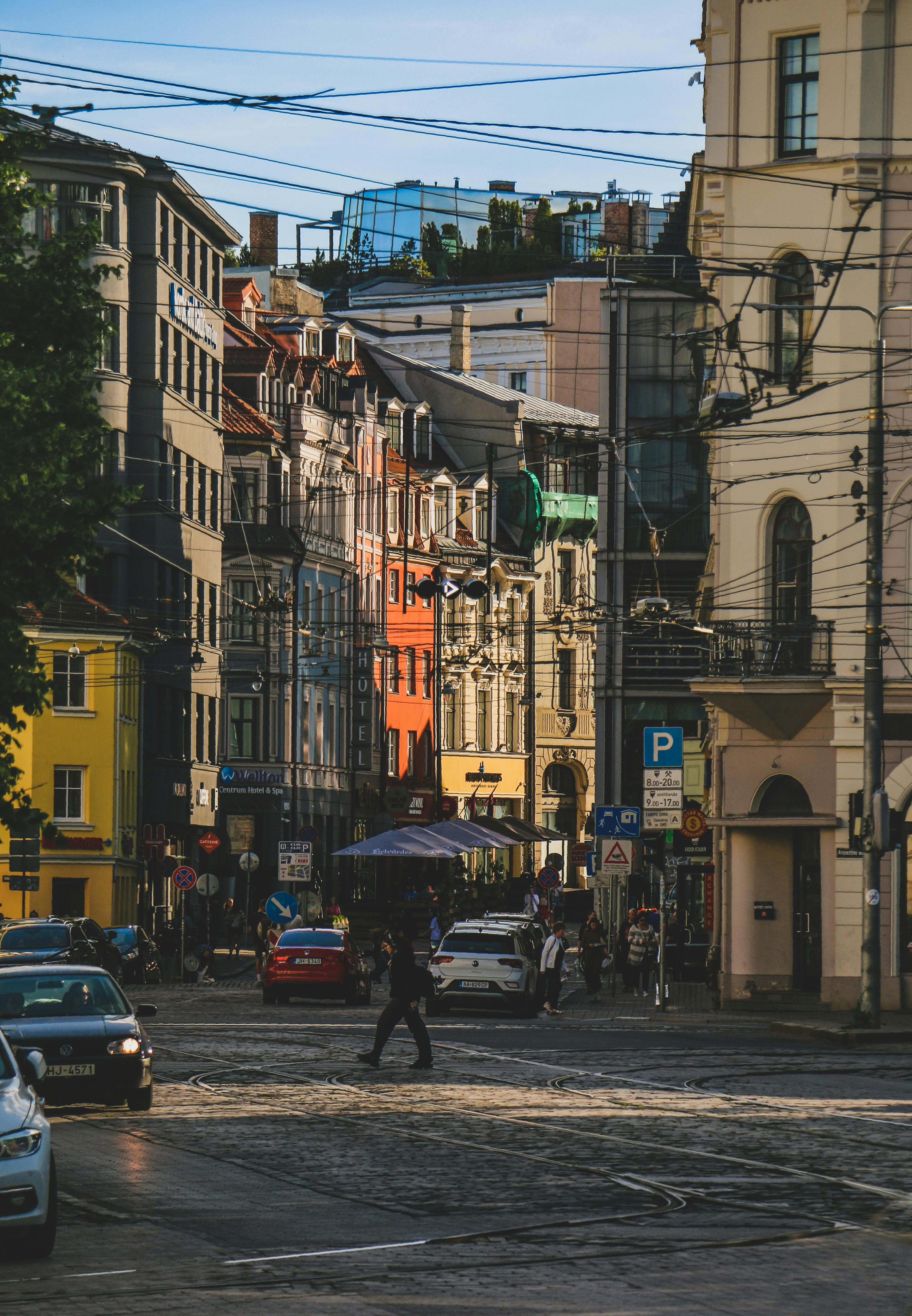 cars and person walking on street in city