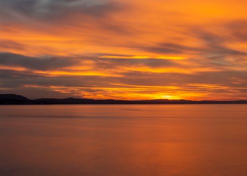 Vibrant sunset with orange and red hues over the ocean in Kandıra, Kocaeli, Türkiye.