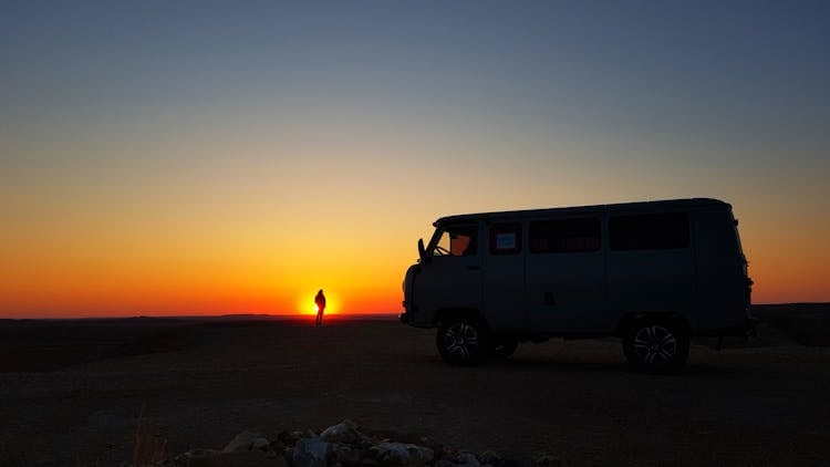 Blue Enclose Van During Sunset Scenery