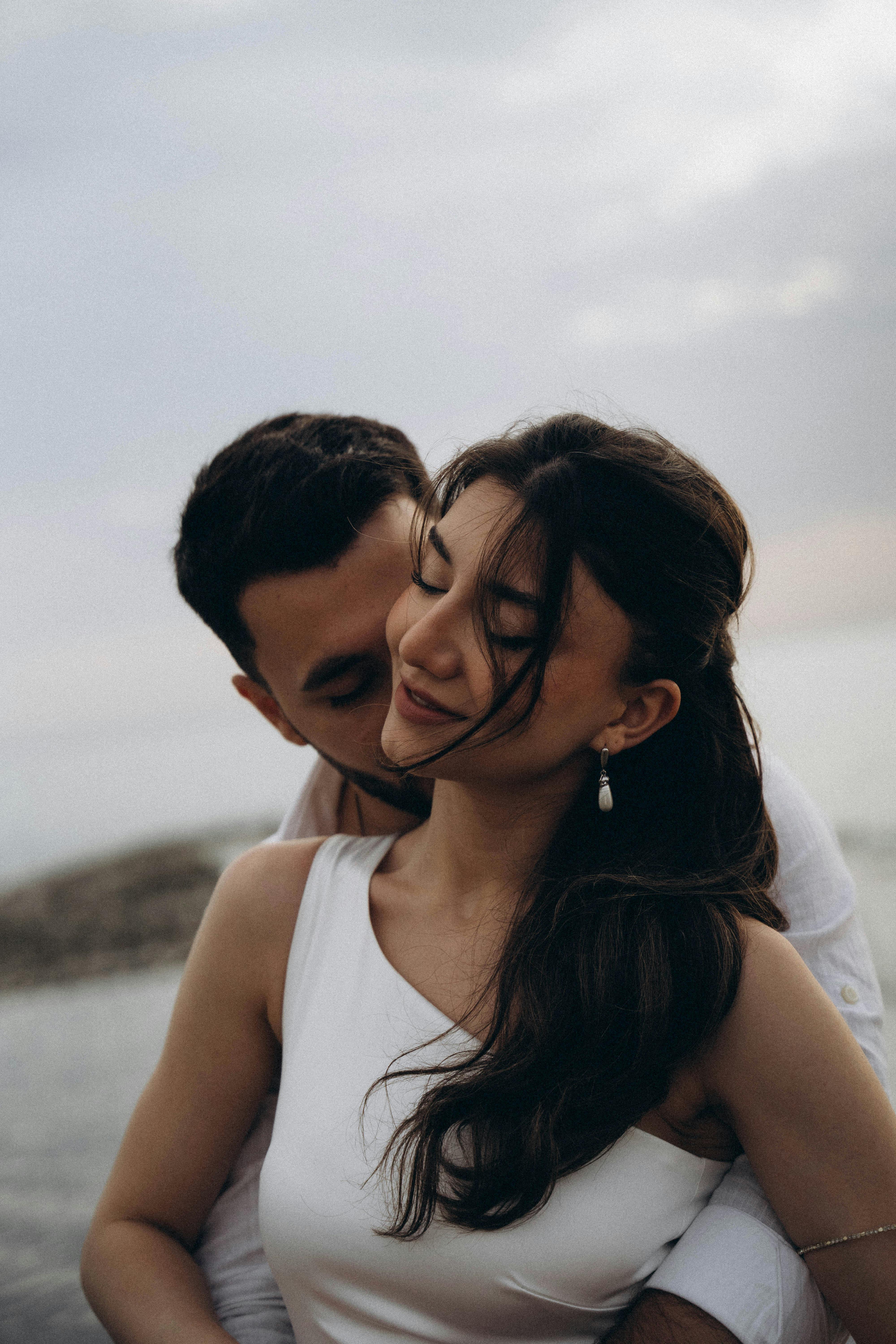 bride is embraced and kissed by the groom