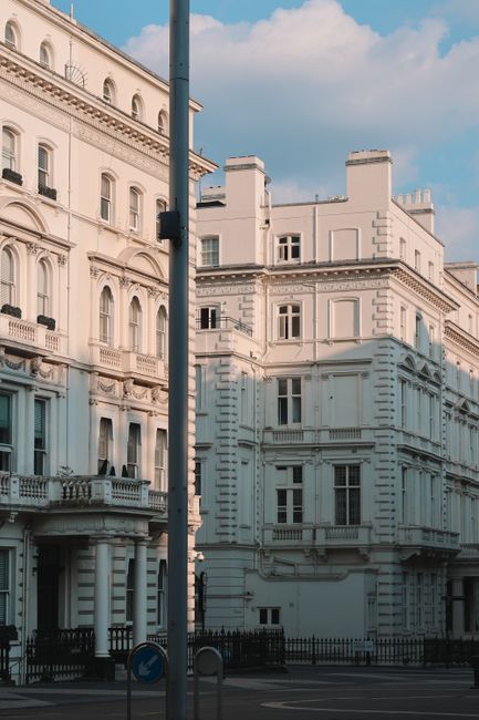 Sunlit white buildings on Exhibition Road in London capture classic architecture.