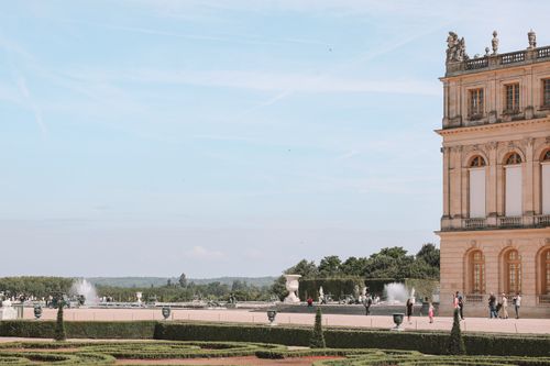 Free View of the Versailles Palace and fountains set against a clear sky in Paris. Stock Photo