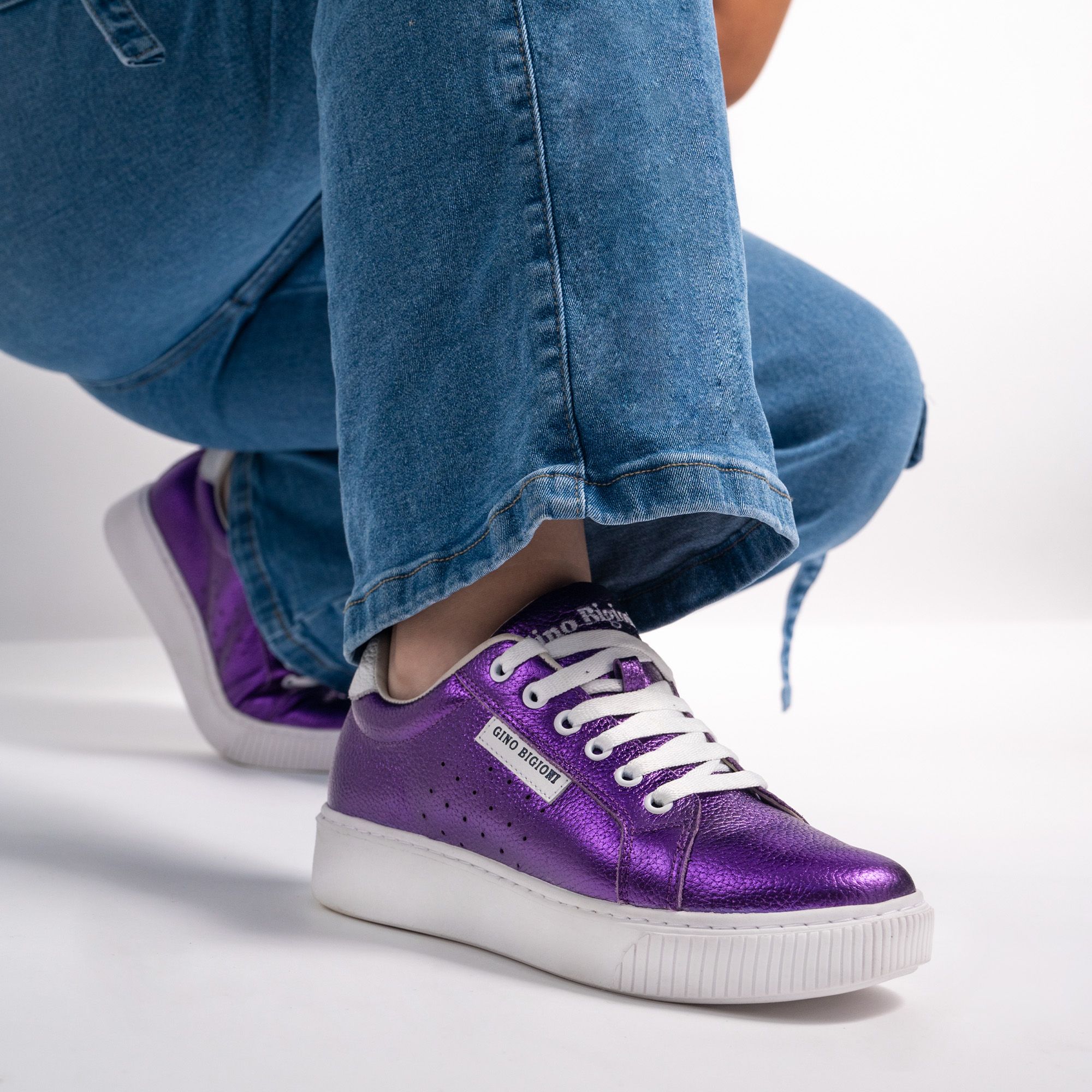 Person Legs in Purple Sneakers and Jeans