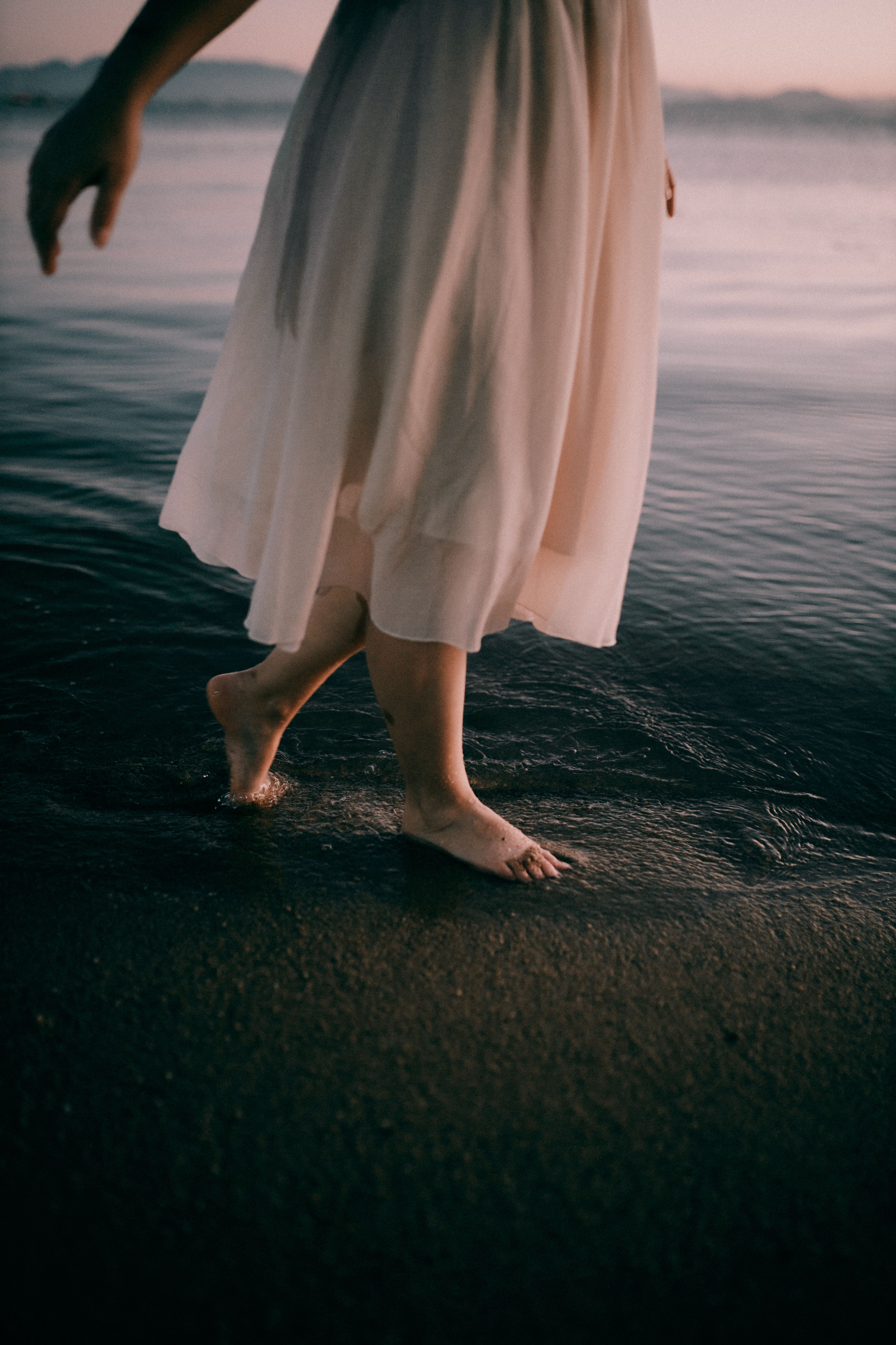 Woman Walking on a Beach in a Dress · Free Stock Photo