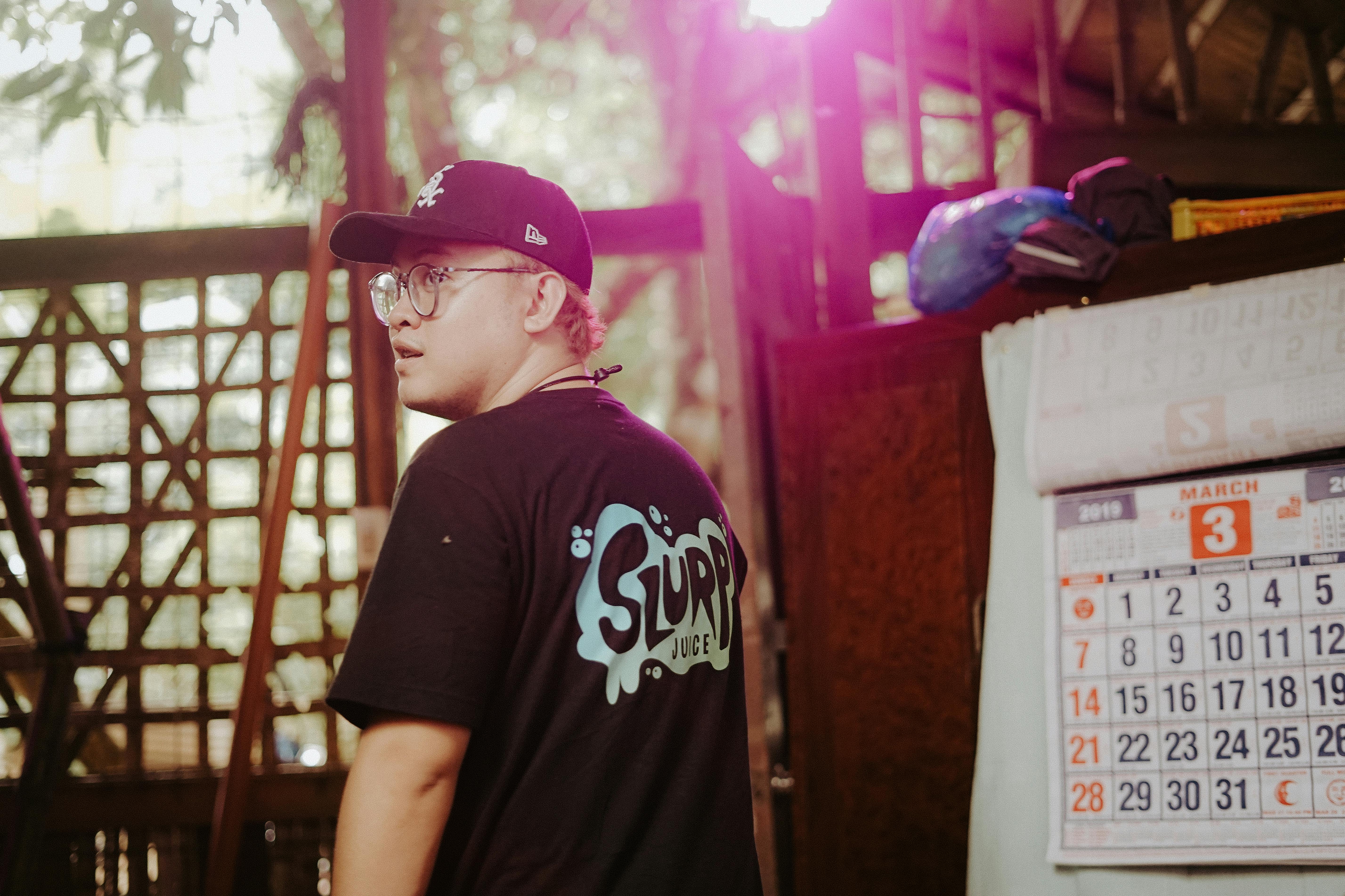 man wearing a t shirt and a cap