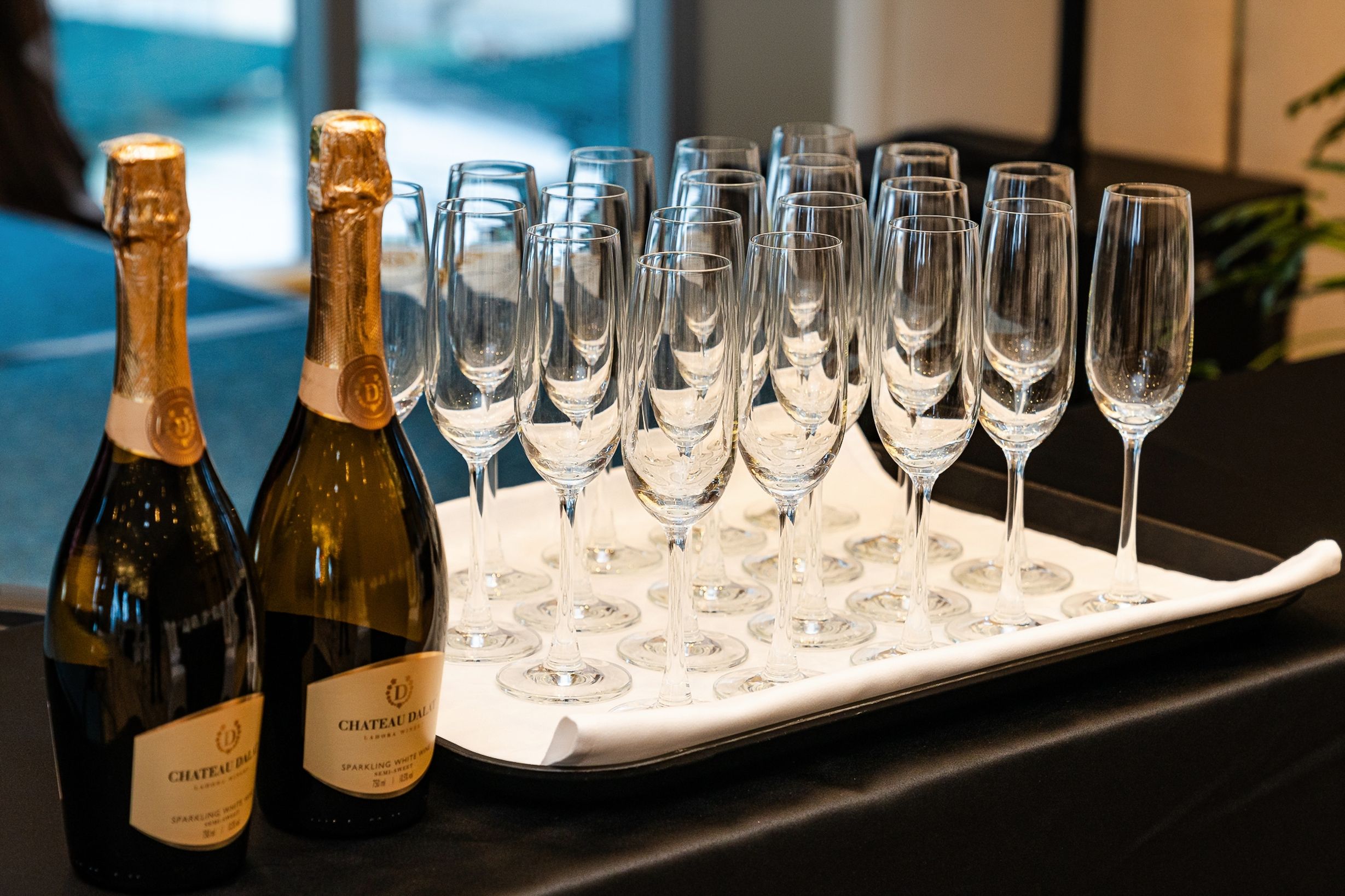 Champagne bottles with glasses on a tray, perfect for upscale celebrations and parties.