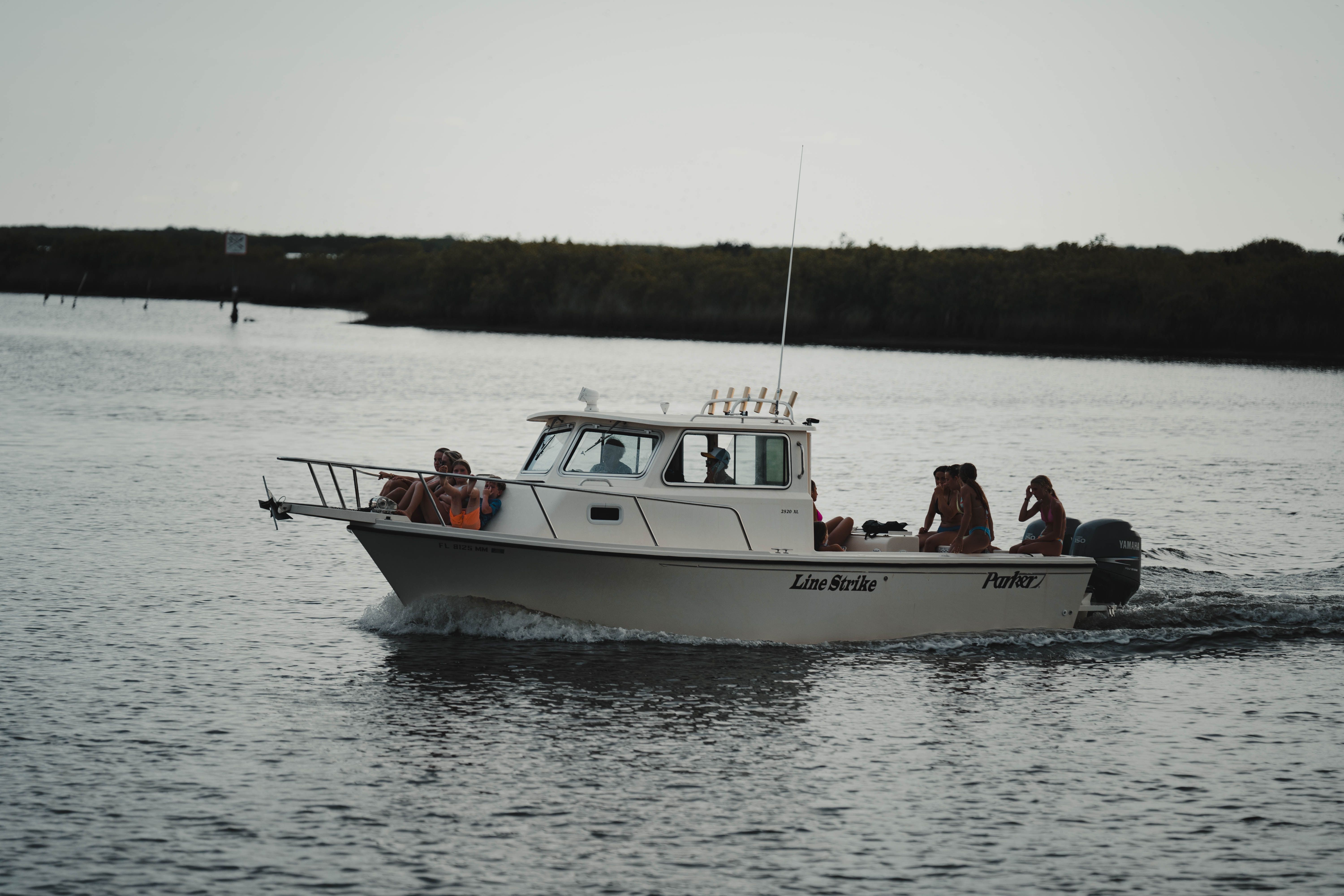 Family enjoying a sunny day on a pontoon boat in calm Florida waters - boat insurance quotes florida