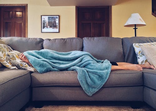 Free Person Lying on Sofa Stock Photo