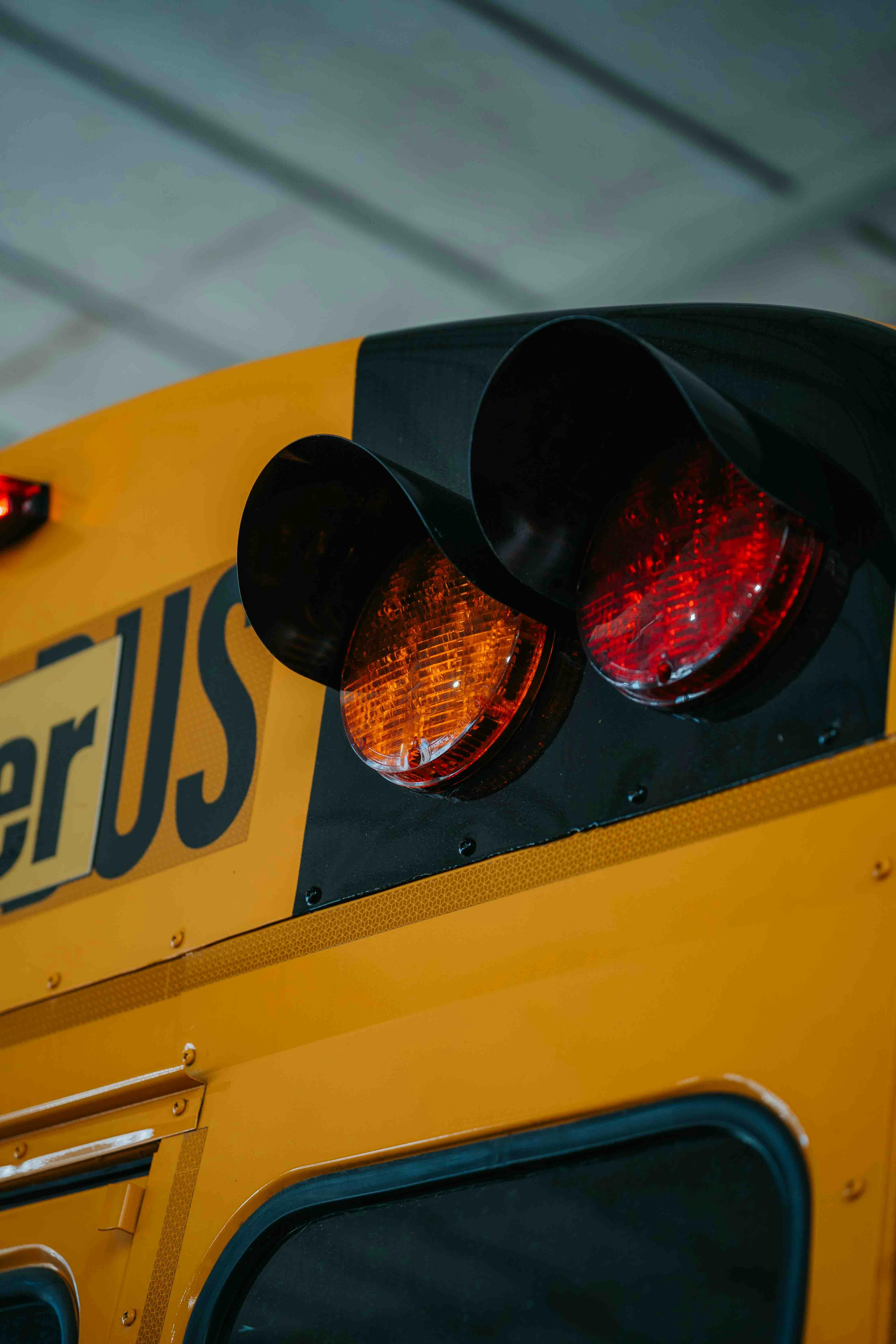 Detailed view of a school bus with focus on lights and signalization.