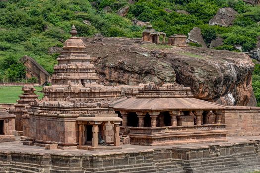 Bhutanatha Temple surrounded by rocky landscape in Badami, showcasing ancient Indian architecture.