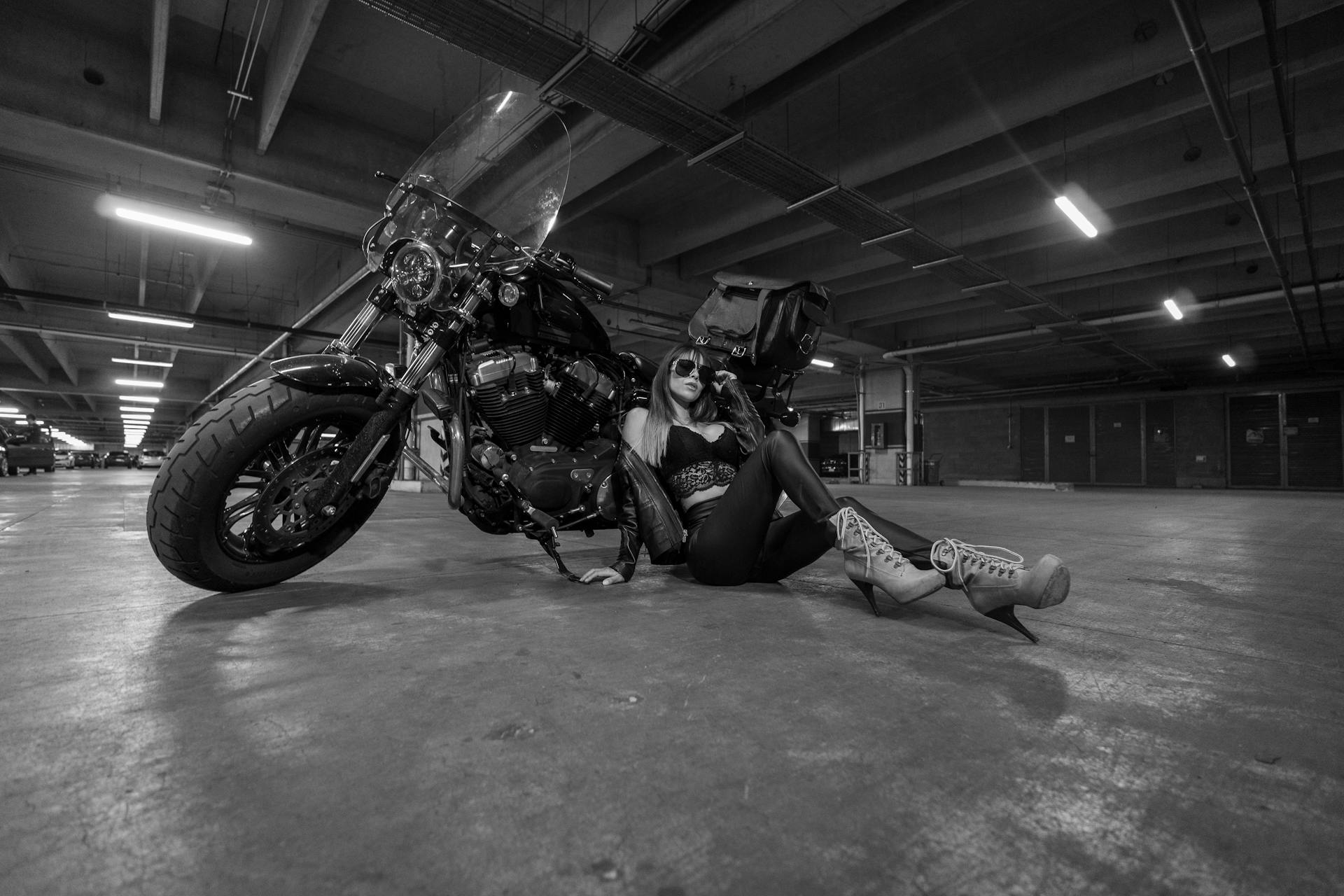 Woman in Sunglasses and Lingerie Sitting with Motorbike in Black and White