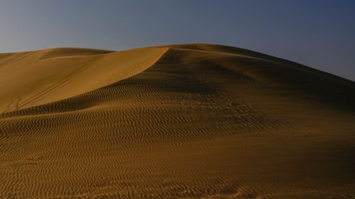 Free Stunning sand dunes under twilight skies in Doha, capturing desert's serene beauty. Stock Photo