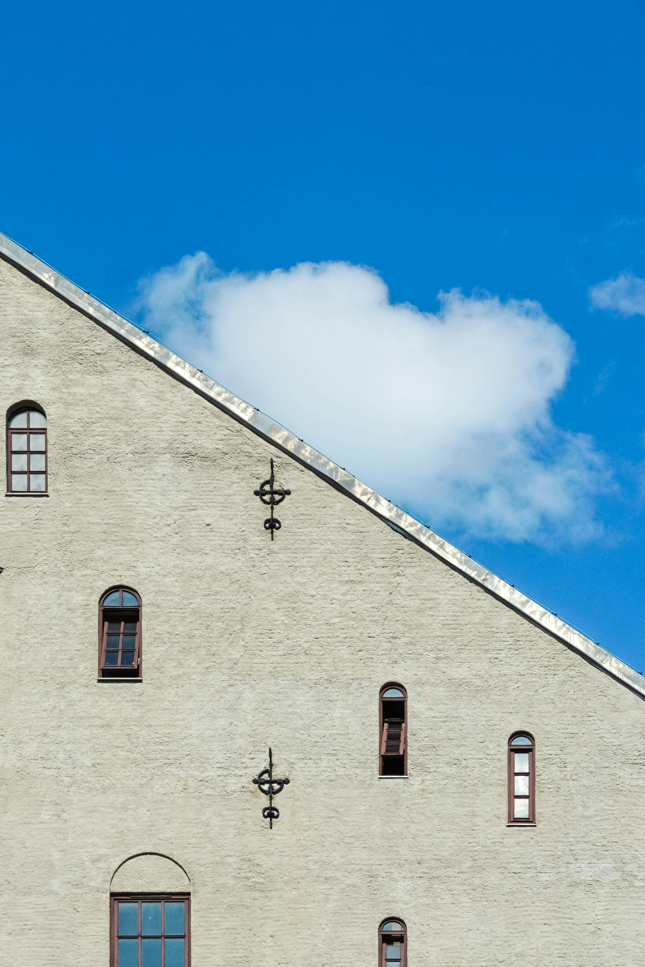 A minimalist architectural detail of a building facade under a blue sky in Oslo, Norway.