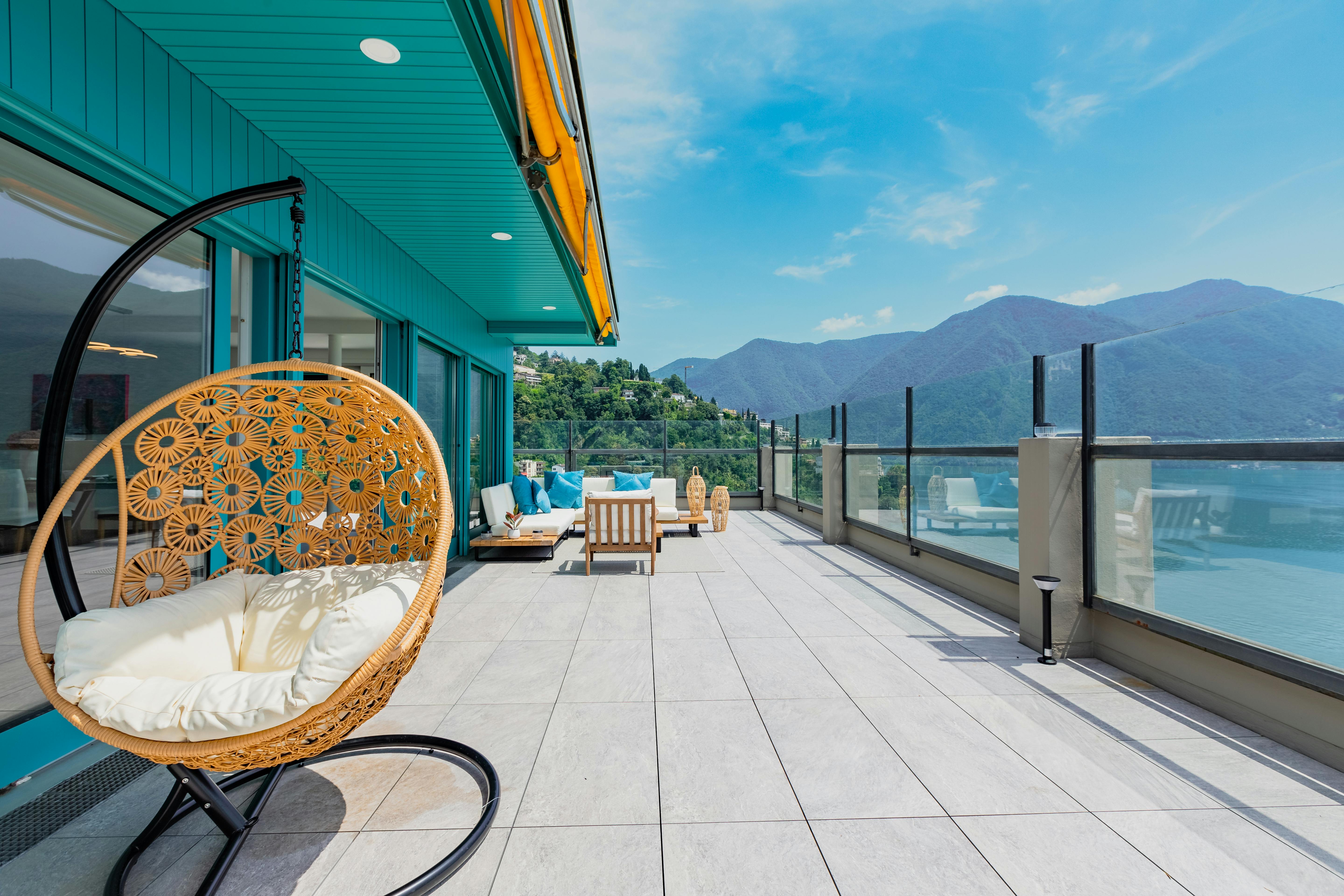 Luxurious terrace overlooking mountains and lake, perfect for relaxation and vacation.