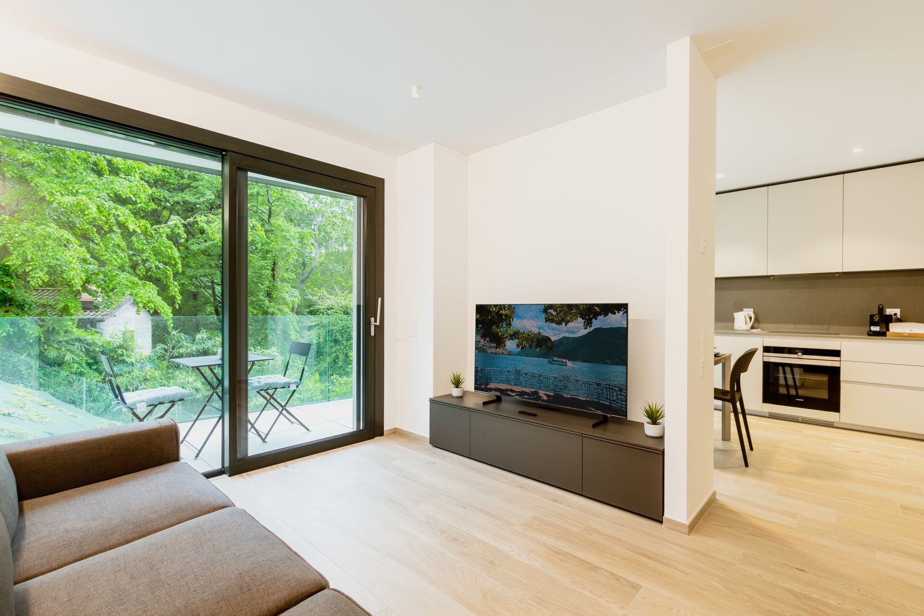 Compact contemporary living room with a restrained television wall and low storage