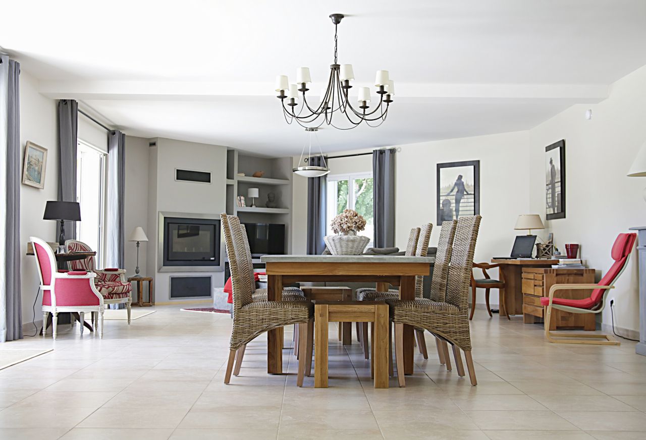 Rectangular wooden table with six gray chairs in a dining room