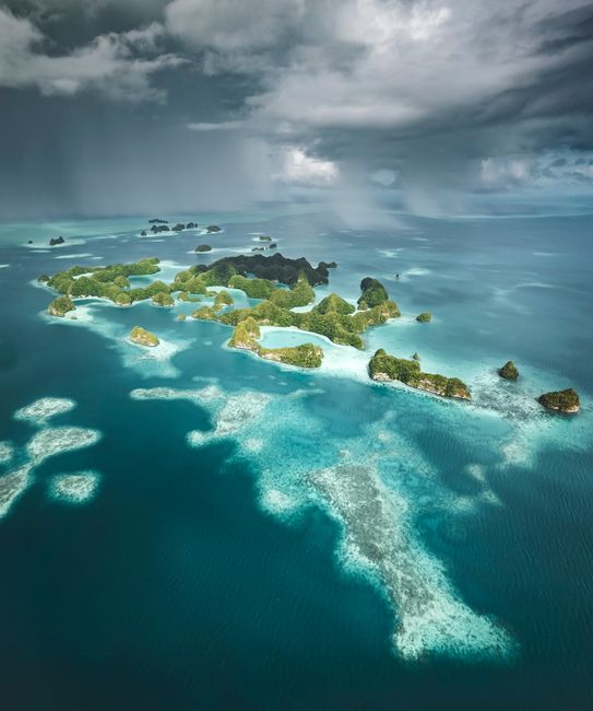 Stunning aerial view of lush tropical islands surrounded by turquoise waters in Palau.