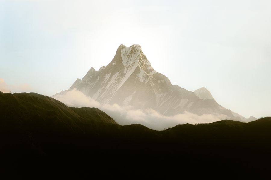 Beautiful view of Machapuchare mountain in Nepal's Himalayas blanketed by clouds.