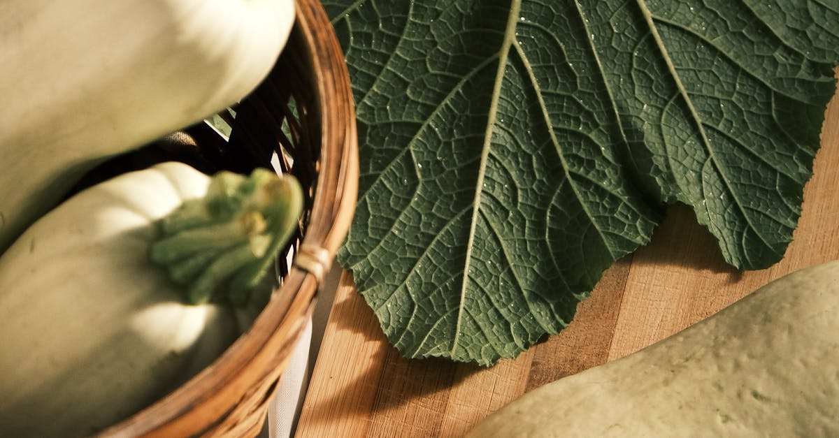 A basket with zucchini and a knife on a cutting board