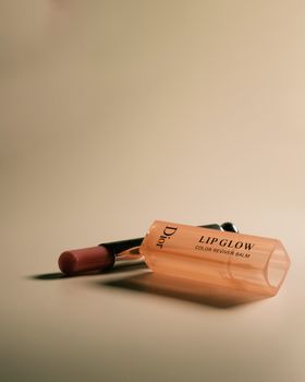 Chic Dior lip balm placed on a simple background, perfect for beauty products.
