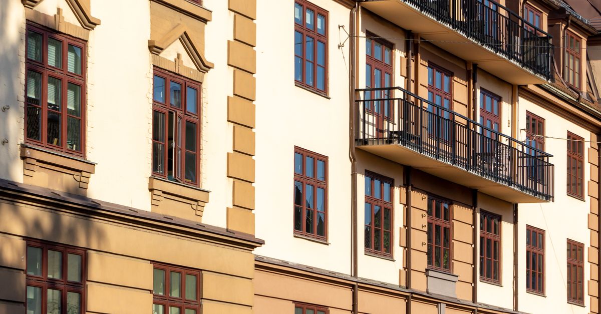 Traditional building facade in Oslo with multiple balconies and windows in sunlight.