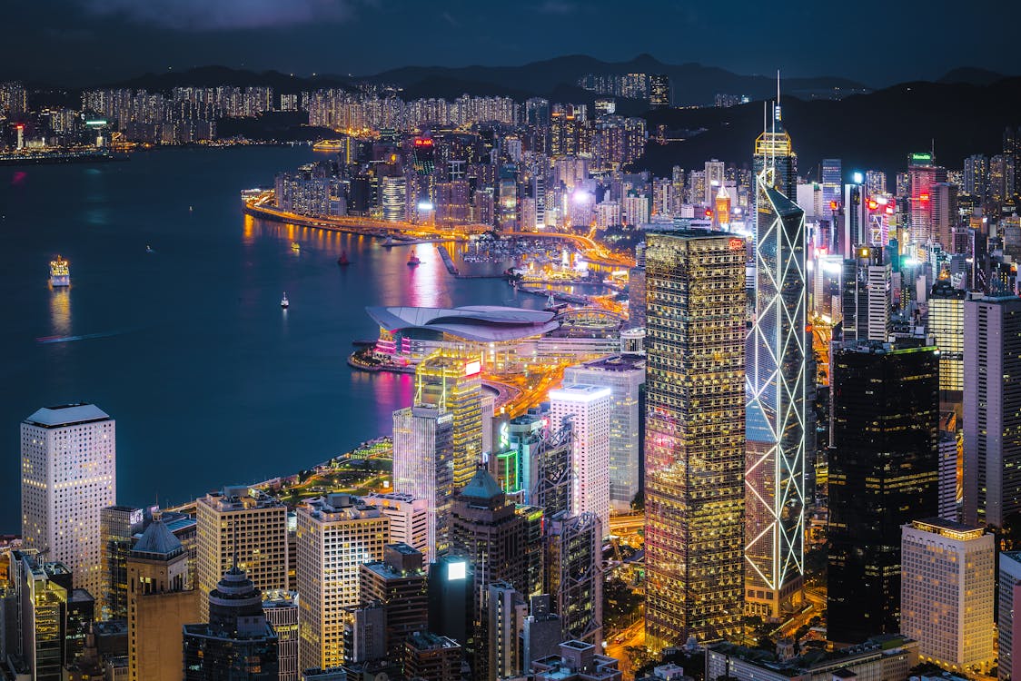 Free City With High-rise Buildings Viewing Sea during Night Time Stock Photo
