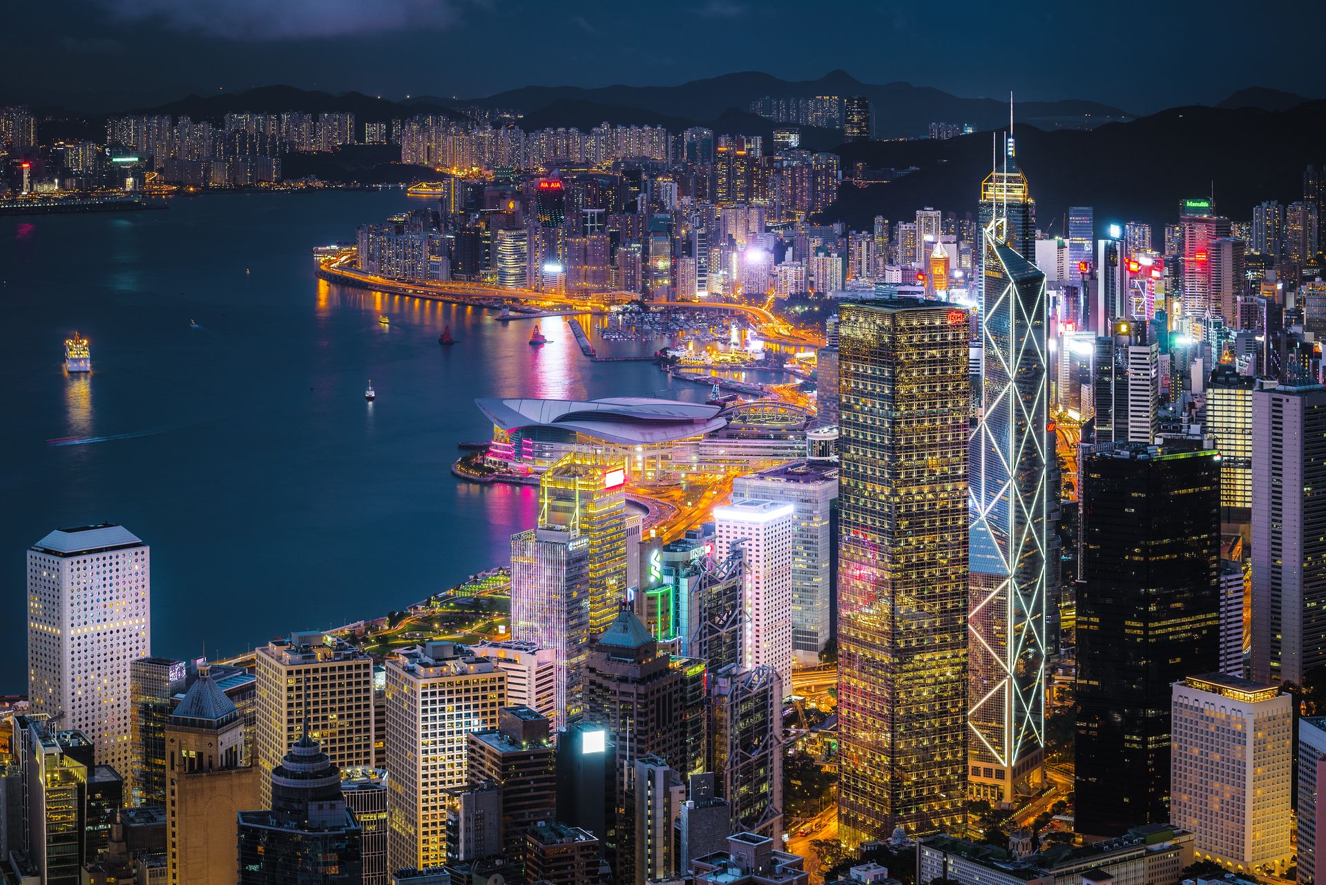 City With High-rise Buildings Viewing Sea during Night Time
