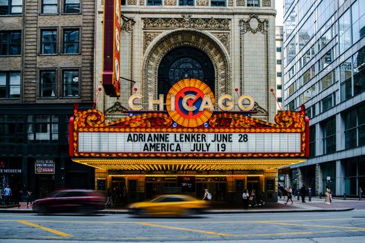 Vibrant Chicago Theater with marquee and busy street, showcasing urban architecture.