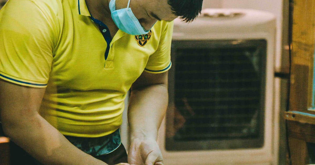 Man in Yellow Shirt Preparing Food