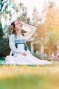 Woman Sitting on Grass Looking Up