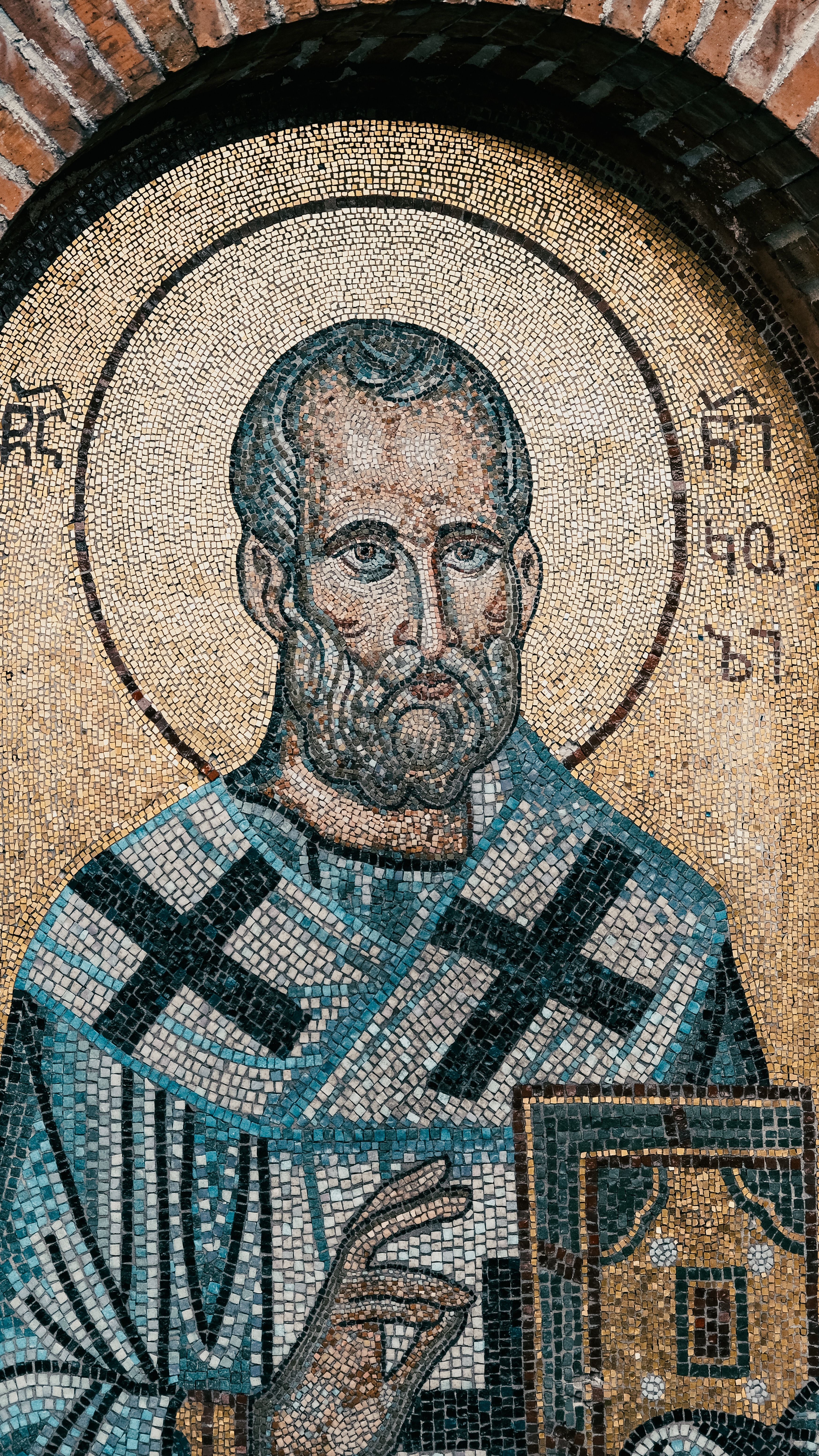 Close-up of a religious mosaic depicting a saint in a church alcove.