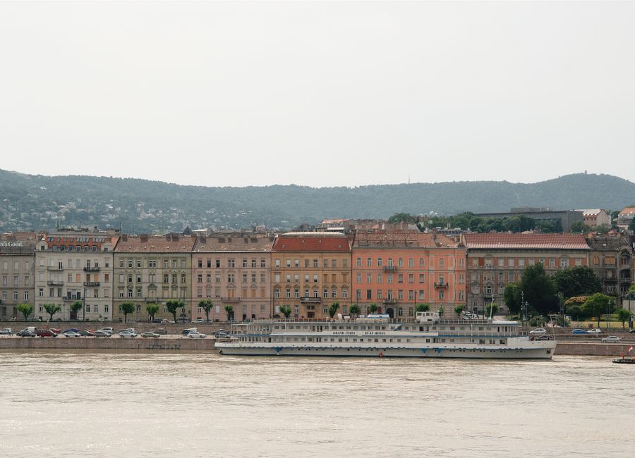 Elegant historical buildings along the Danube river in Budapest, Hungary viewed from a scenic angle.