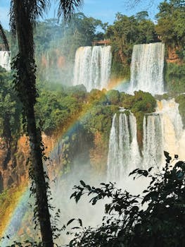 Stunning view of Iguazu Falls in Argentina with a vibrant rainbow.