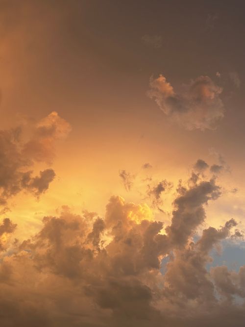 Free Capture the beauty of a dramatic sunset with vibrant clouds and a golden sky. Stock Photo