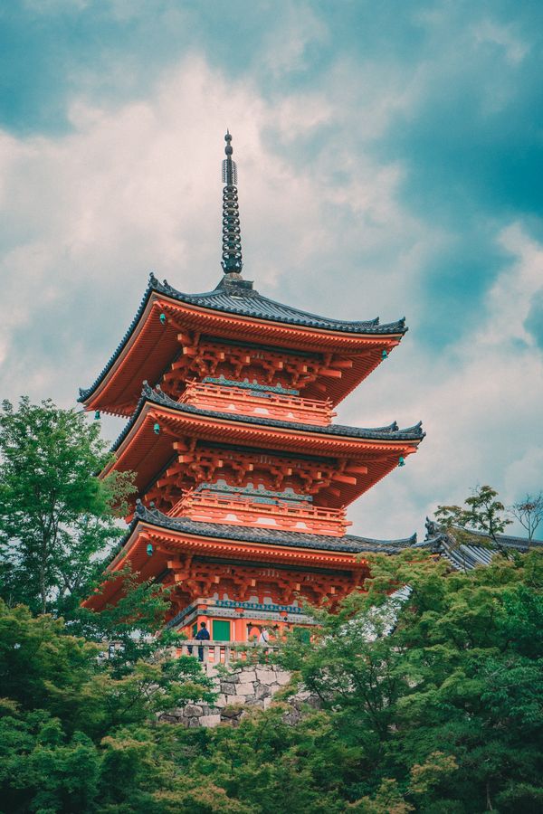 Vermilion pagoda framed by maple trees in Kyoto — photo by miyou_ 77 on Pexels
